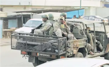  ?? — Reuters photo ?? Soldiers of Ivorian special forces drive through the city of Adiake, Eastern Ivory Coast.