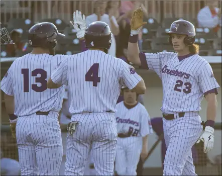  ?? JENNIFER FORBUS — FOR THE MORNING JOURNAL ?? Brody Wofford (23) is greeted at the plate by teammates Trevor Achenbach (13) and Connor Oliver (4) after slugging a home run.