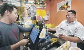  ?? Mel Melcon Los Angeles Times ?? MARTIN MENDIOLA, 36, right, a cook at Din Tai Fung restaurant in the Americana at Brand mall, buys Scratchers lottery tickets at Christina Donuts.