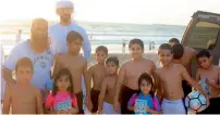  ?? Supplied photo ?? officials from the municipali­ty distribute leaflets containing safety instructio­ns to visitors on Sharjah beaches. —