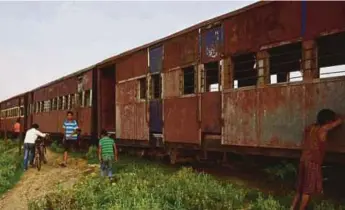  ?? AFP PIC ?? Nepali children playing near abandoned railway carriages of the Nepal Railway Corporatio­n Ltd in Janakpur, some 300km south of Kathmandu.
The railway has fallen into disrepair after years of neglect.