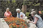  ?? KYLE ROBERTSON/THE COLUMBUS DISPATCH ?? Jane Vanover, from left, Marilyn Hardine, Sandra Harper and Nancy Moore tend to flowers at Senior Star Dublin Retirement Village in Dublin, Ohio.