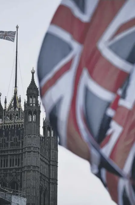  ??  ?? 2 Union Jack flags hang in parliament square to mark Britain’s exit from the European Union