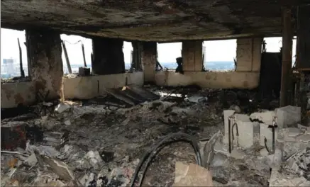  ?? METROPOLIT­AN POLICE, THE ASSOCIATED PRESS ?? A view of a Grenfell apartment after fire engulfed the 24-storey building. Experts believe the exterior cladding helped spread the flames quickly.
