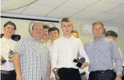  ??  ?? ARJFL U16 player Tom Evans receives the Supporters’ POY award from coaches Andrew Stevenson and Michael Warren