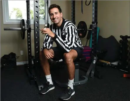  ?? PETER LEE, RECORD STAFF ?? Andrew Smith in his home workout room where he stays in shape in order to perform his job as an on-ice official in the National Hockey League. A decade ago, the Kitchener man was officiatin­g games for $12 an hour at Pat Doherty Arena.