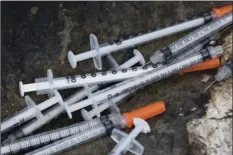  ??  ?? This July 31 file photo shows discarded syringes in an open-air heroin market that has thrived for decades, slated for cleanup along train tracks a few miles outside the heart of Philadelph­ia. Philadelph­ia wants to become the first U.S. city to allow...