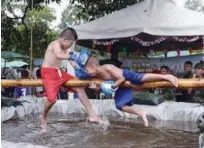  ?? Agence France-presse ?? Children play on a bamboo pole suspended over a pool of water in Narathiwat on Saturday.