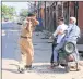  ?? PTI ?? A policeman tries to get rid of commuters during curfew in Jaipur on Saturday.