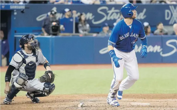  ?? — THE CANADIAN PRESS ?? Blue Jays’ Justin Smoak watches his two-run home run against Tampa Bay in the sixth inning of Saturday’s game in Toronto. The Jays beat the Rays 4-1 to snap a three-game losing streak. The teams play again Sunday in the rubber match.