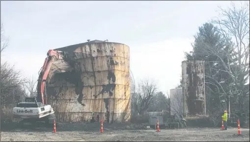  ?? The Associated Press ?? TEARING DOWN TANK: In this Dec. 11, 2017, photo a tank at a Kiel Bros. facility is torn down in Indianapol­is. The collapse of Kiel Bros. Oil Co. in 2004 was widely publicized. Less known is that the state of Indiana and, to a smaller extent, Kentucky...