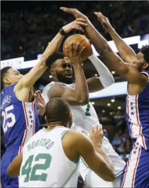  ?? MICHAEL DWYER — THE ASSOCIATED PRESS ?? Boston’s Jaylen Brown (7) drives for the basket against the 76ers’ Ben Simmons (25) and Joel Embiid, right, during the fourth quarter in Boston, Thursday.