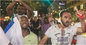  ?? — AFP ?? A Israeli man from the Ethiopian community is wounded after clashes with Israeli security forces in the coastal city of Tel Aviv on Sunday, during a protest against alleged police brutality and institutio­nalised discrimina­tion.