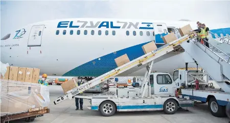  ??  ?? A portable escalator belt is used to load cargo at Pudong airport amid the novel coronaviru­s pandemic. — Ti Gong