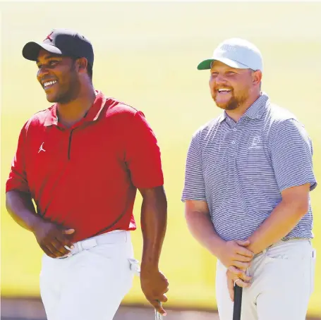  ?? RONALD MARTINEZ/GETTY IMAGES ?? Harold Varner III, left, and Zac Blair were all smiles on the 18th green during the first round of play at the Charles Schwab Challenge on Thursday at Colonial Country Club in Fort Worth, Texas. Varner shot a 7-under 63 and shares the lead with Justin Rose.