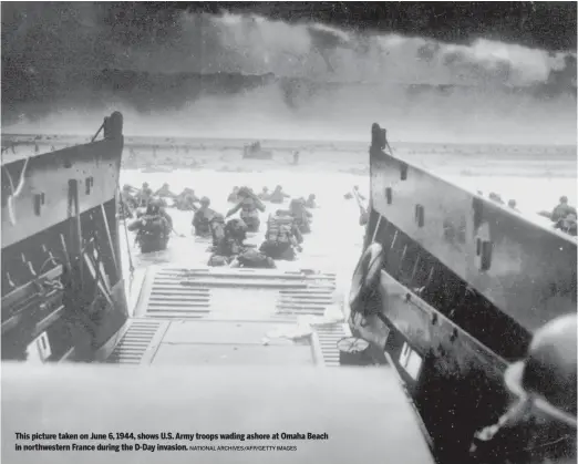  ?? NATIONAL ARCHIVES/AFP/GETTY IMAGES ?? This picture taken on June 6, 1944, shows U.S. Army troops wading ashore at Omaha Beach in northweste­rn France during the D-Day invasion.