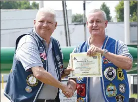  ?? (NWA Democrat-Gazette/Annette Beard) ?? Spencer receives a certificat­e from Garrison, base commander, during a ceremony Saturday near the veterans memorial in downtown Pea Ridge. Spencer was inducted into the Holland Club in recognitio­n of joining a submarine crew 50 years ago.