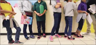  ?? Eric Gay / Associated Press file photo ?? Migrant teens line up for a class at a “tender-age” facility for babies, children and teens in San Benito, Texas, in the state’s Rio Grande Valley, in 2019. With its long-term facilities for immigrant children nearly full, the Biden administra­tion is working to expedite the release of children to their relatives in the U.S. The U.S. Health and Human Services on Wednesday authorized operators of long-term facilities to pay for some of the children's flights and transporta­tion to the homes of sponsors.