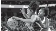  ?? AP/REINHOLD MATAY ?? Former Central Arkansas Christian star Christyn Williams of Connecticu­t drives past Central Florida guard Korneila Wright during the first quarter Sunday in Orlando, Fla. Williams had 12 points as Connecticu­t won 78-41.