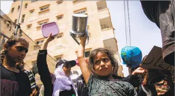  ?? Ahmad Salem Bloomberg ?? MORE THAN 80% of those facing imminent famine — 577,000 people — were in the Gaza Strip, the U.N. said. South Sudan, Burkina Faso, Somalia and Mali are also in crisis. Above, Palestinia­ns rally for aid Thursday.