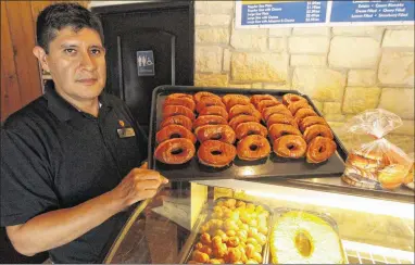  ??  ?? Round Rock Donuts store manager Polo Garcia said the bakery is often visited by celebritie­s and has been showcased on several TV food series. “I don’t want to brag about it, but good comments are always welcome,” he said.