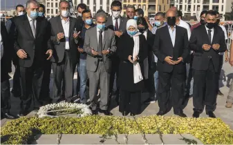  ?? Chris McGrath / Getty Images ?? Bahiya alHariri, the sister of Lebanon’s former Prime Minister Rafik Hariri, prays at his grave in Beirut. No suspects in his assassinat­ion were ever arrested and none were in court.