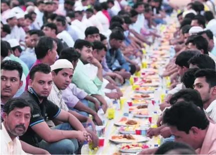  ?? Saleh Al Shaibany for The National ?? Residents of Muscat’s Al Seeb neighbourh­ood pay restaurant­s to provide homeless workers with free meals.