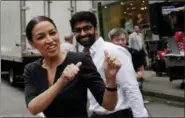  ?? MARK LENNIHAN - THE AP ?? Alexandria Ocasio-Cortez, the winner of a Democratic Congressio­nal primary in New York, greets a passerby in New York, Wednesday, the morning after she upset U.S. Rep. Joe Crowley in Tuesday’s primary election.