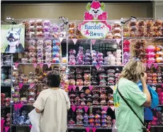  ??  ?? Dog groomers and owners browse accessorie­s at the Groom Expo.