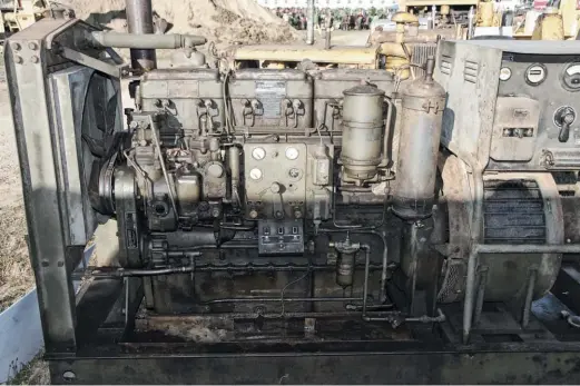  ??  ?? pthe Cummins H-series diesel debuted in 1931 and it’s derivative­s are still produced today in some parts of the world. The Model H was inarguably the foundation of Cummins’ success. This is an HI industrial series engine with direct electric starting. It used a Cummins designed and built single disc injection pump. The oil pan holds 12 gallons of oil and combined with a 24 gallon cooling system, plus a huge oil cooler, this unit was designed to run for days or weeks at a stretch at a full load. Your 1943 tax dollars at work! Mike has the covers off the back of the generator head and exciter for inspection and cleaning.