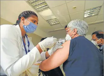  ?? SUNIL GHOSH/HT PHOTO ?? As many as 319 out of a total of 325 registered beneficiar­ies took their first shot across the three hospitals in the Gautam Budh Nagar district on Monday.