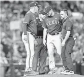  ?? MARK J. REBILAS/USA TODAY SPORTS ?? Rangers pitcher Max Scherzer is removed from Game 3 of the World Series with an injury.