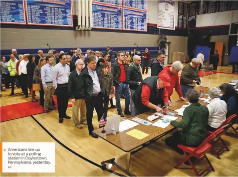  ?? AP ?? Americans line up to vote at a polling station in Doylestown, Pennsylvan­ia, yesterday.