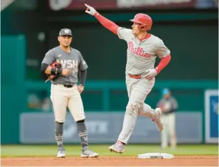  ?? JESS RAPFOGEL/GETTY ?? Philadelph­ia Phillies catcher J.T. Realmuto rounds the bases after hitting a three-run homer against the Washington Nationals on Saturday in Washington.