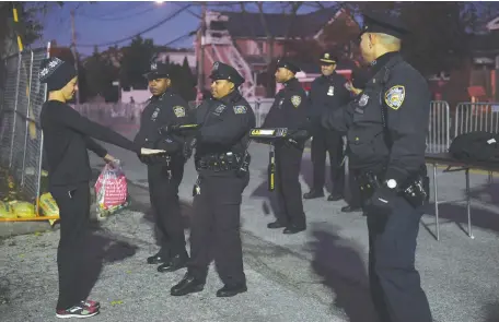  ?? (Reuters) ?? NEW YORK Police Department officers conduct searches before the New York City Marathon on November 4: ‘US police don’t have the time or resources to do what technology could quickly get done.’