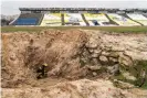  ?? Marfisi/AGF/Rex/Shuttersto­ck ?? An operation to remove debris is under way at the stadium. Photograph: Nicola