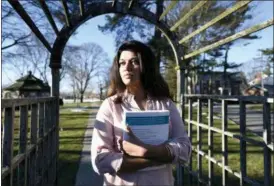  ?? KATHY KMONICEK — THE ASSOCIATED PRESS ?? Naila Amin, 26, holds a book from one of the classes she was taking at Nassau Community College in Garden City, N.Y. According to data provided to The Associated Press, the U.S. approved thousands of requests by men to bring child and teenage brides from another country. “My passport ruined my life,” said Naila Amin, a dual citizen from Pakistan who grew up in New York City.