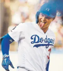  ?? Mark J. Terrill, The Associated Press ?? Los Angeles Dodgers right fielder Joc Pederson enjoys himself while looking at his own dugout after hitting a solo home run during the first inning Monday night against the Rockies. L. A. won 16- 9.