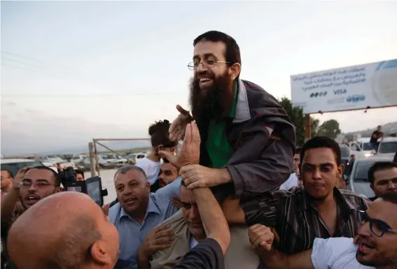  ?? ?? Palestinia­n Khader Adnan, centre, is greeted by Palestinia­ns after his release from an Israeli prison in the West Bank village of Arrabeh near Jenin, Sunday, July 12, 2015. Palestinia­n prisoner Adnan died in Israeli custody early Tuesday, May 2, 2023, after a hunger strike of nearly three months, Israel’s prison service announced. Photo: Majdi Mohammed, AP File