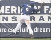  ?? MORRY GASH — THE ASSOCIATED PRESS ?? The Brewers’ Lorenzo Cain can’t catch a double hit by the Cubs’ Jason Heyward during the 11th inning Monday.