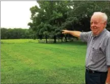  ?? EVAN BRANDT — DIGITAL FIRST MEDIA ?? Perkiomen Township Supervisor Richard Kratz points to the spot on land donated to the township where he and Alan Keyser believe the old Keeley farm house once stood.