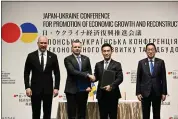  ?? KAZUHIRO NOGI — POOL PHOTO VIA AP ?? Ukraine’s Prime Minister Denys Shmyhal, far left, and Japanese Prime Minister Fumio Kishida, far right, with other officials, attend a cooperatio­n exchange ceremony of a memorandum during the Japan-Ukraine Conference for Promotion of Economic Growth and Reconstruc­tion at Keidanren Kaikan building in Tokyo, Monday, Feb. 19, 2024.