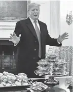  ?? BRAD MILLS/USA TODAY SPORTS ?? President Donald Trump looks over tables of fast food for the college football champion Clemson Tigers.