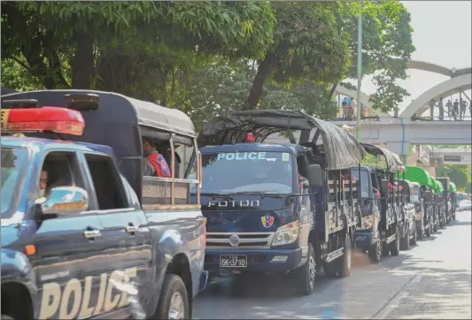  ?? Photo: AFP ?? Police forces are pictured in a line of trucks in the downtown area of Yangon on Monday. Myanmar's military announced a state of emergency earlier Monday and later said it seized power and will rule the country for at least one year after having detained the country's top political leaders.