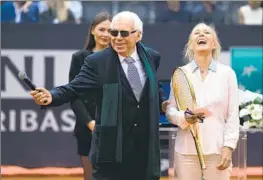  ?? Alex Pantling Getty Images ?? MARTINA NAVRATILOV­A is awarded the Golden Racket by former Italian tennis standout Nicola Pietrangel­i in recognitio­n of her contributi­ons to the sport.