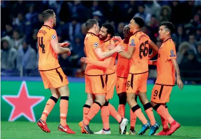  ?? AP file ?? Liverpool’s Mohamed Salah (third left) celebrates after scoring his side’s second goal against Porto in the first leg. —