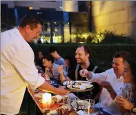  ?? PHOTOS PROVIDED TO CHINA DAILY ?? Dietmar Haubold serves up currywurst at Kempinski Hotel in Beijing.