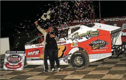  ?? RICH KEPNER - FOR DIGITAL FIRST MEDIA ?? Ray Swinehart gets a hug from wife Lori after winning the Forrest Rogers Memorial at Grandview on Sept. 1.