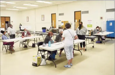  ?? Tyler Sizemore / Hearst Connecticu­t Media ?? Poll workers assist in the special election at the District 8 polling center at Stillmeado­w School in Stamford on Tuesday.