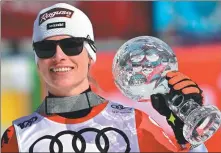  ?? AFP ?? Switzerlan­d's Lara Gut Behrami celebrates with the crystal globe after the women's giant slalom event in the FIS Ski Alpine World Cup in Saalbach, Austria on Sunday.